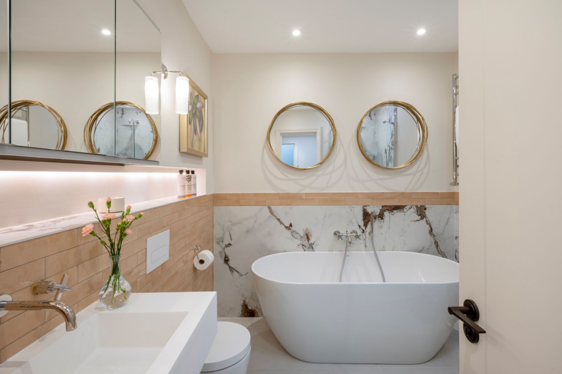 Bathroom with marble accents and a freestanding bath.