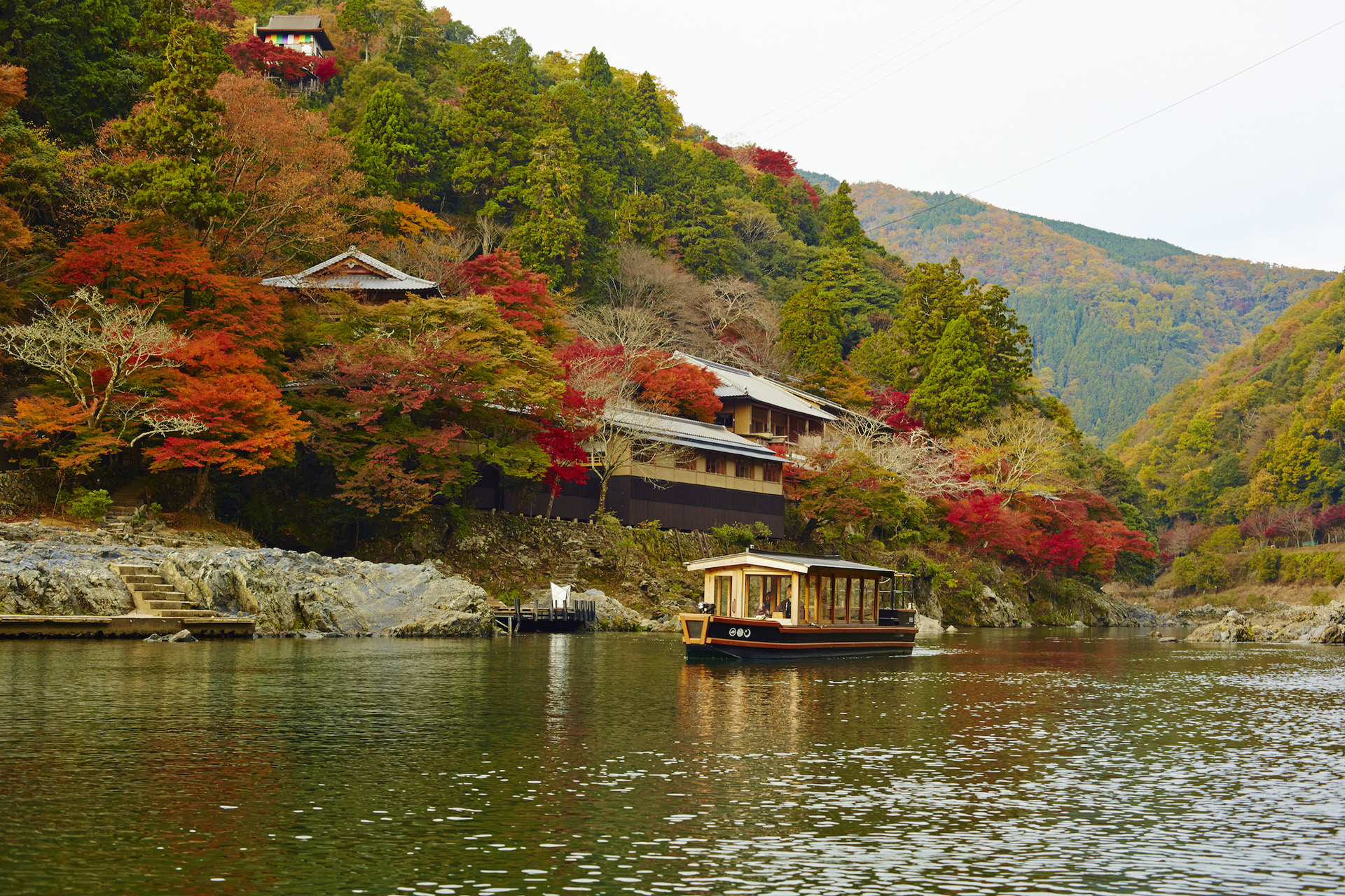 A boat outside HOSHINOYA Kyoto in autumn