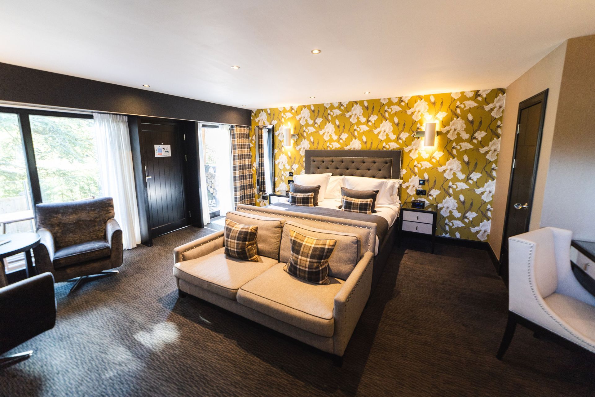 Hotel bedroom with yellow floral wallpaper