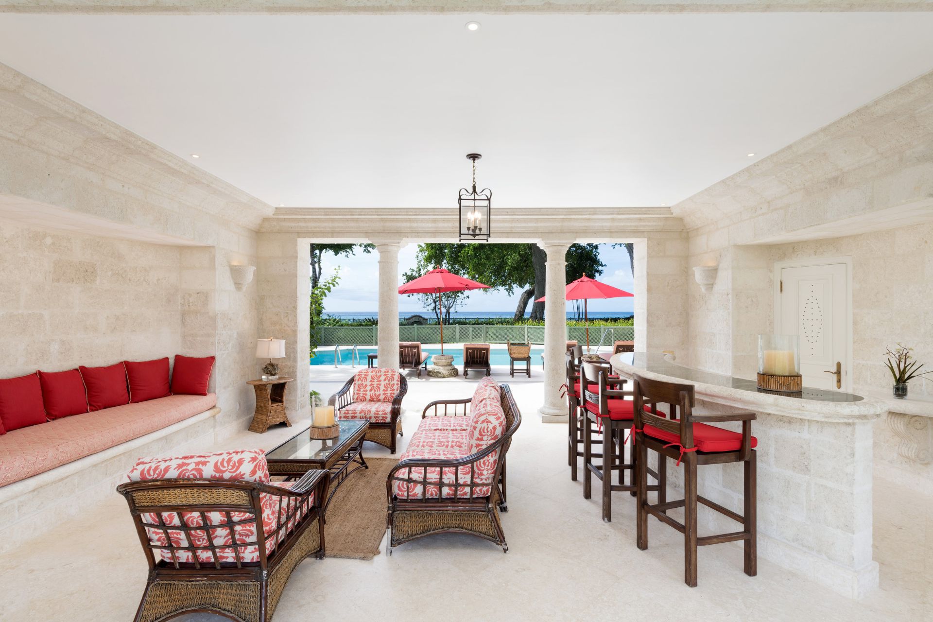 Lounge area with red sofas and bar stools