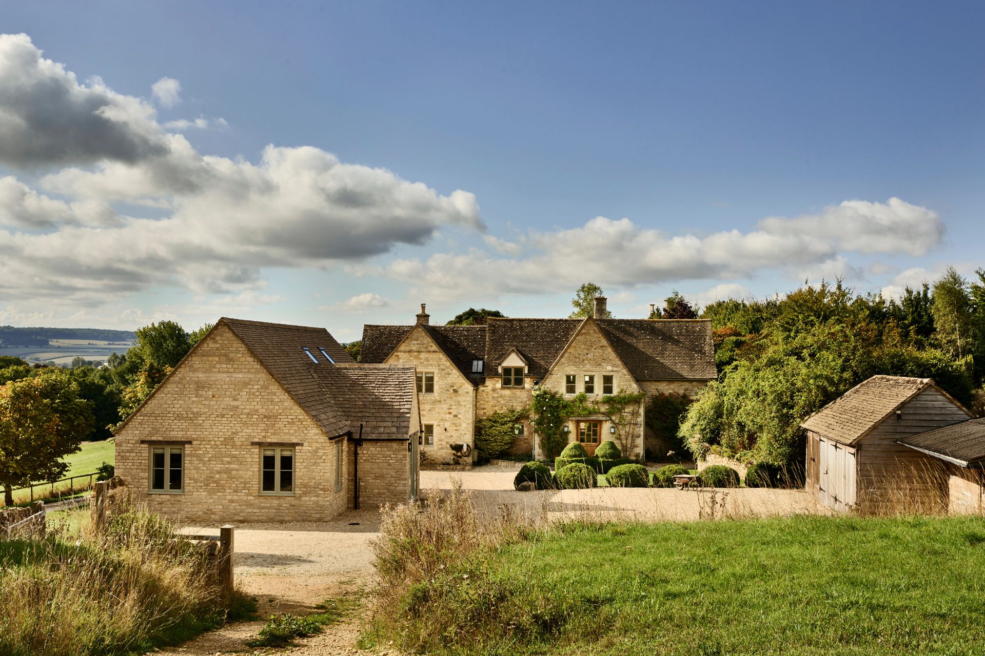 Cotswolds farm with lawns and stone outbuildings