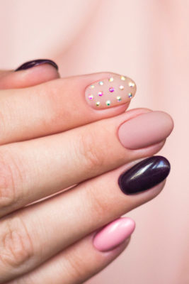 Close up of hand with diamante rhinestone nails