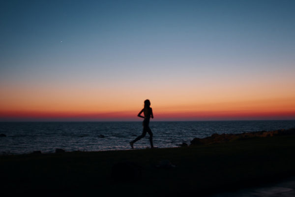 Woman running at sunset on the beach