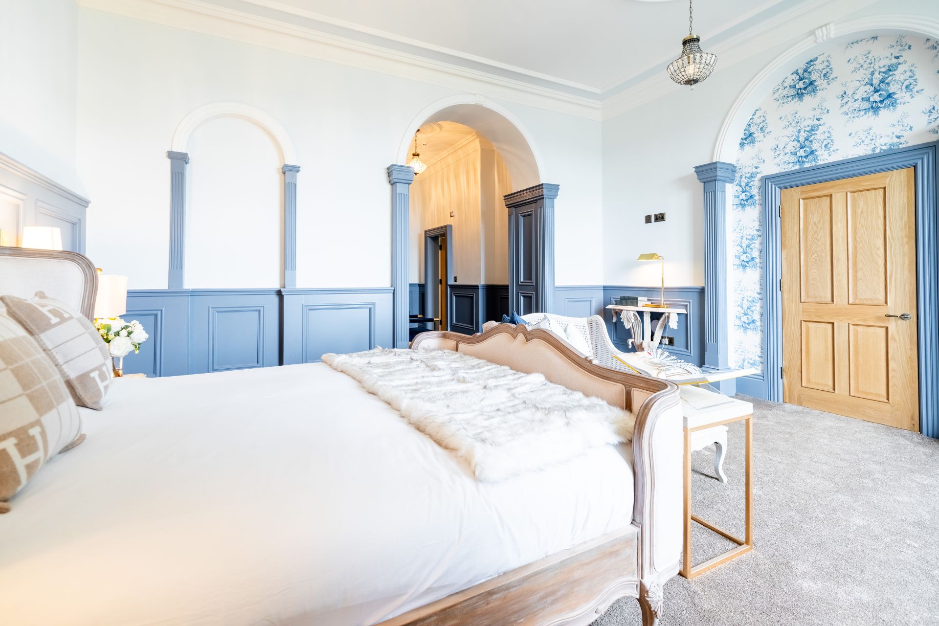 Bedroom with blue panelling and white bed linen