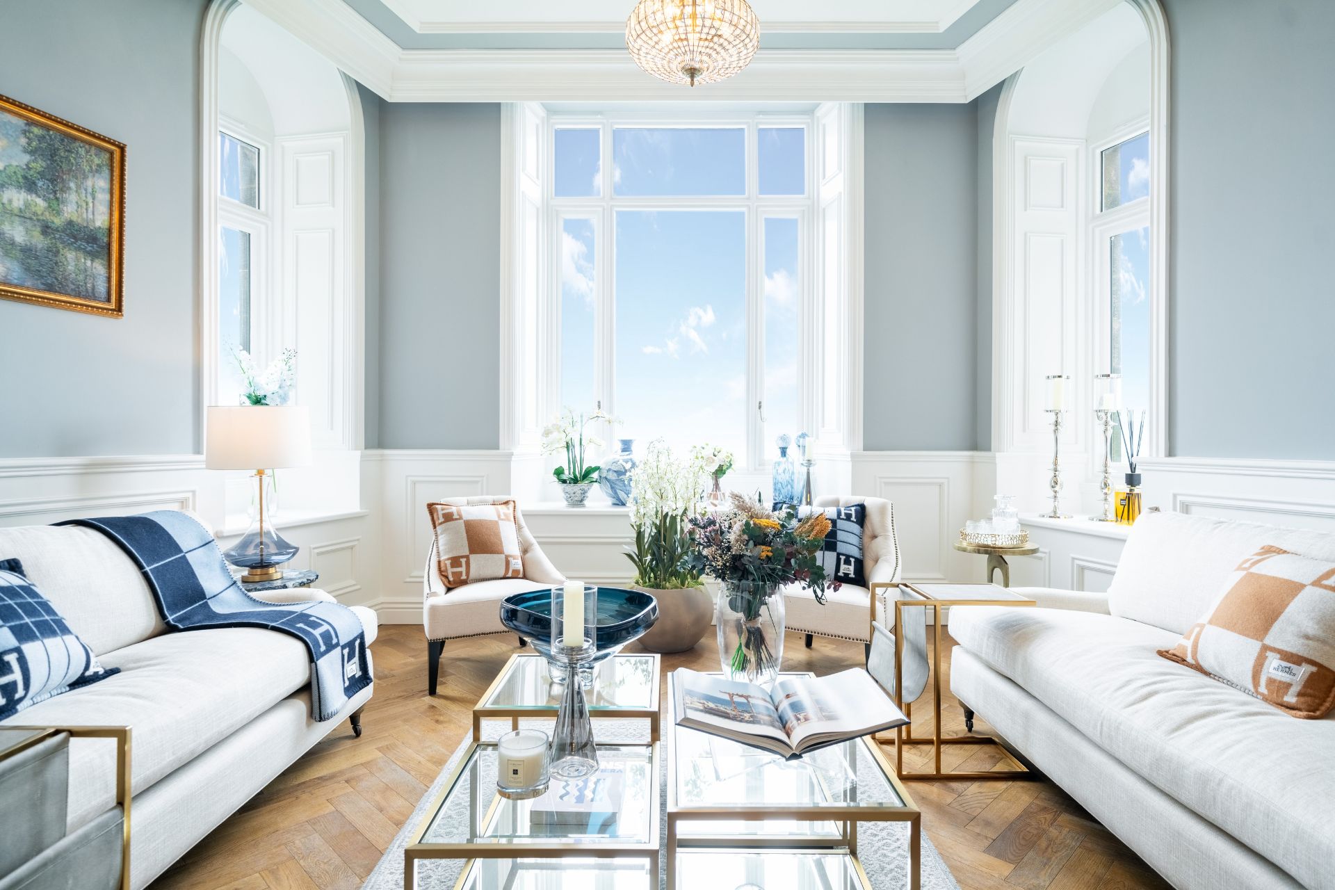 Living room with cream sofas and floor-to-ceiling bay 