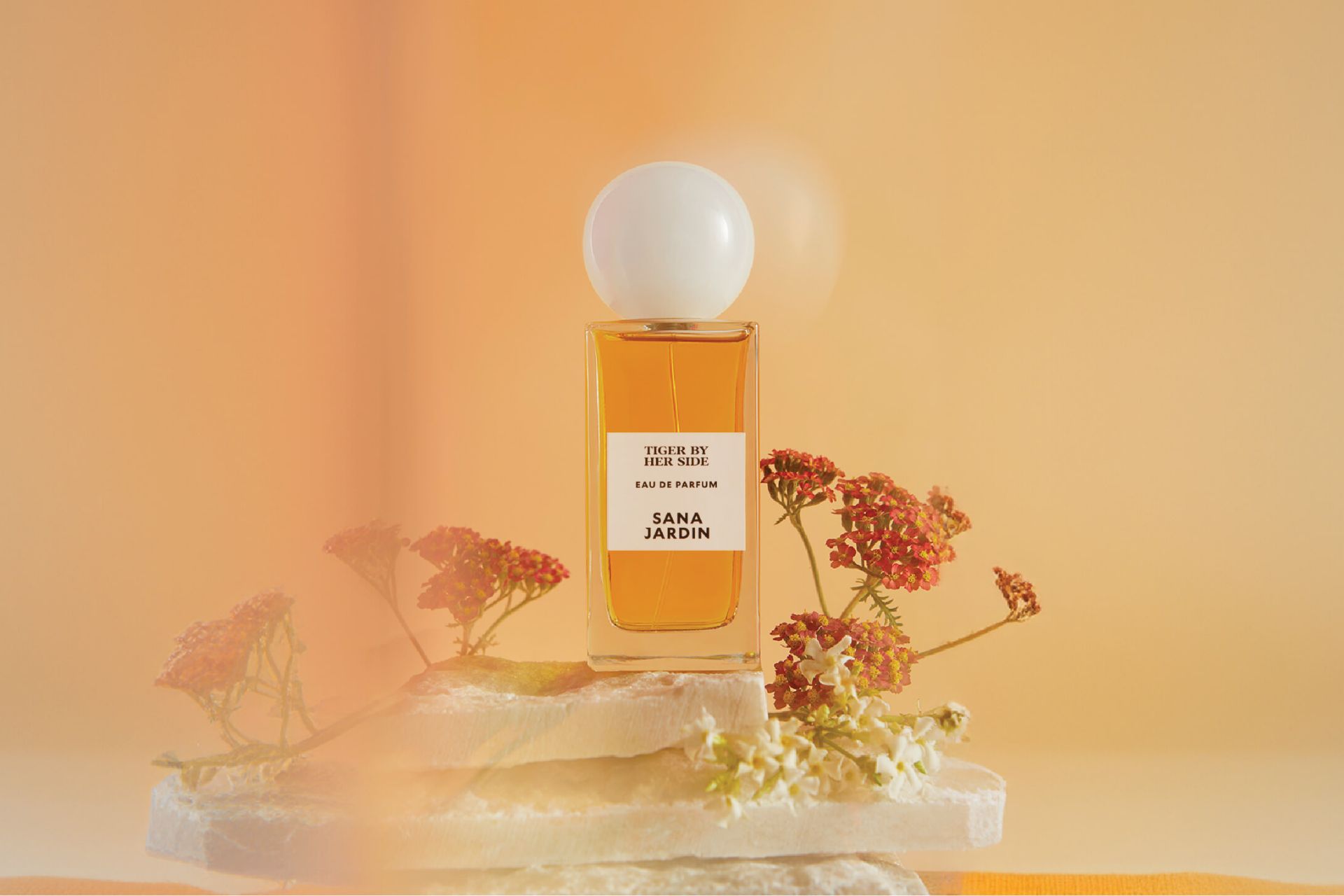 Sana Jardin perfume against a peach-coloured backdrop