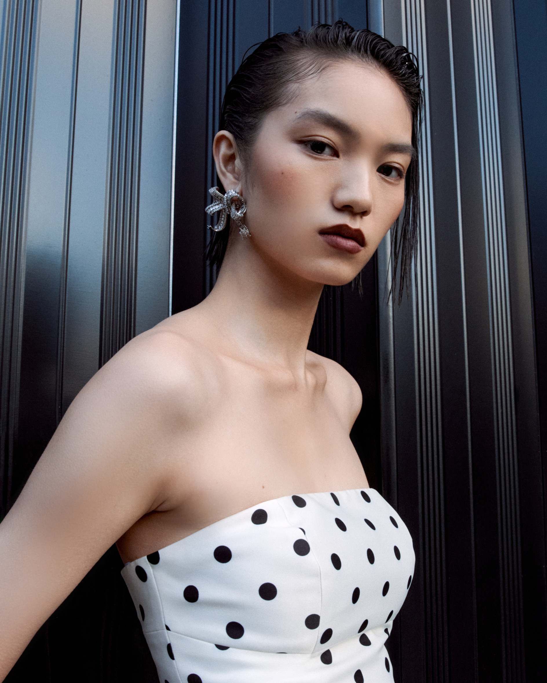 Model wearing bow earrings