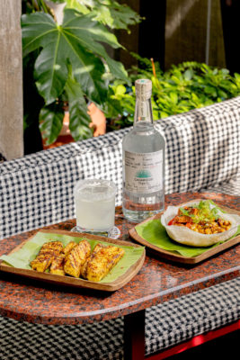 Plates of food and cocktails in a restaurant garden