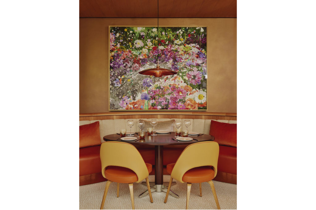 Two chairs looking at a Damien Hirst painting