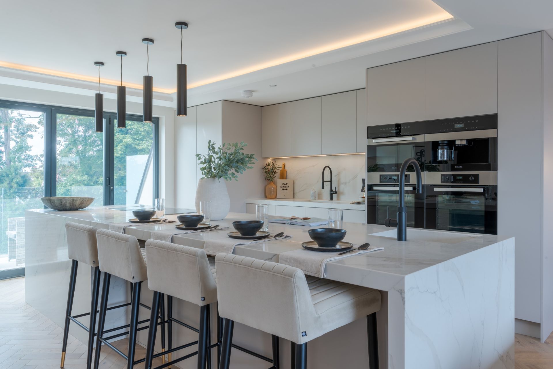 Kitchen with marble island and white chairs