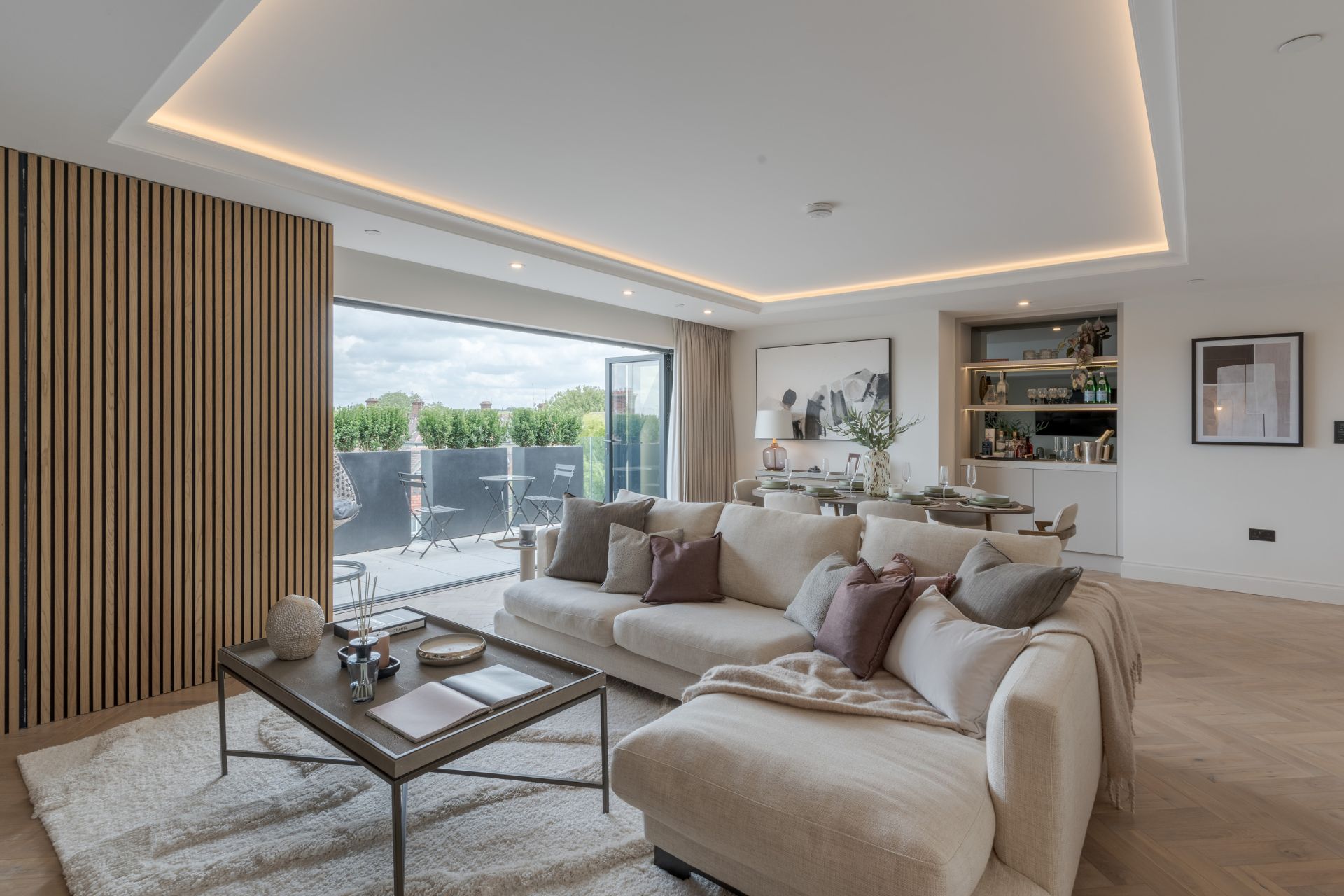 Living room with wood panelled feature wall and cream corner sofa