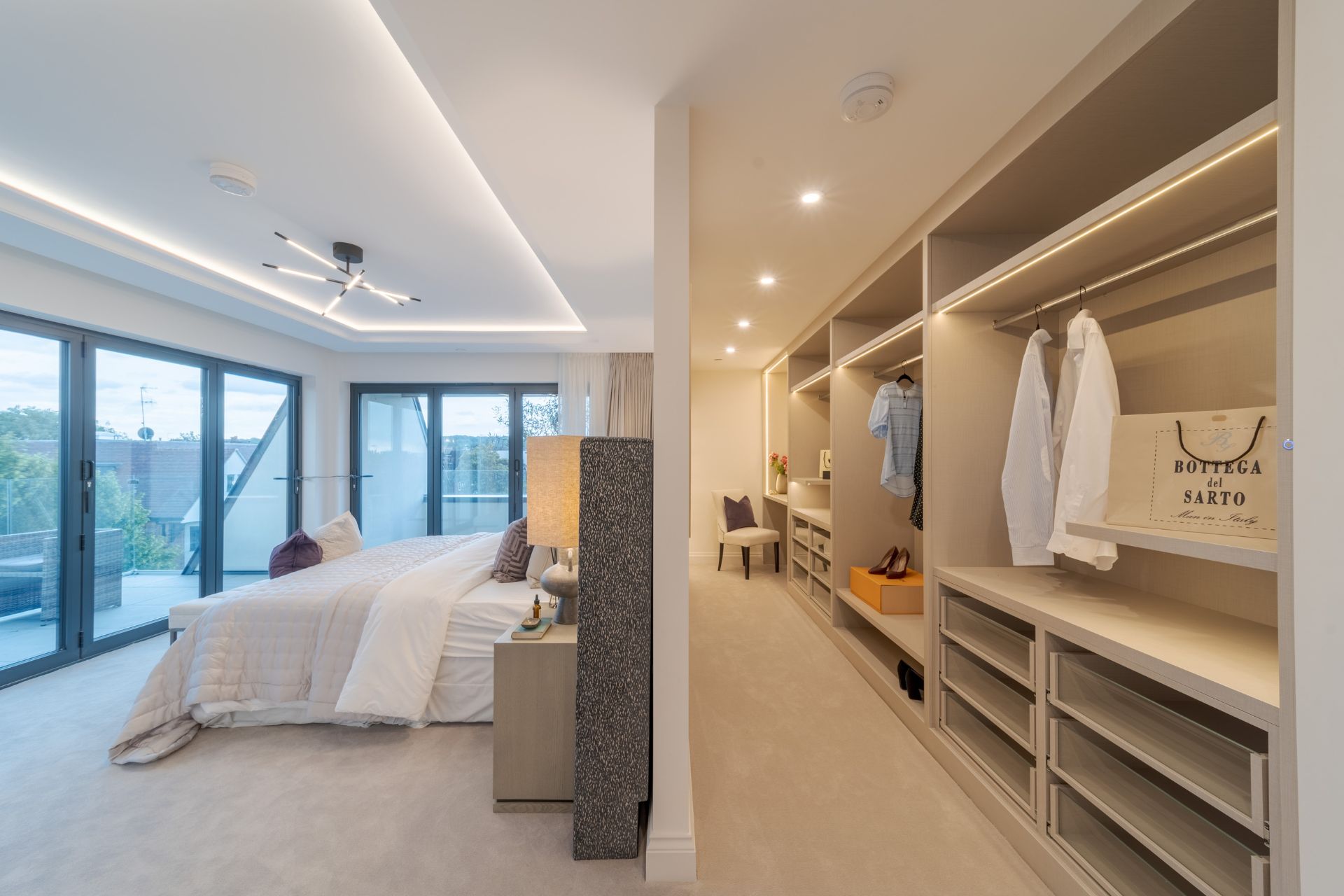 Bedroom with floor-to-ceiling windows and walk-in wardrobe