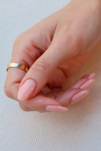 Hand with naked nails manicure