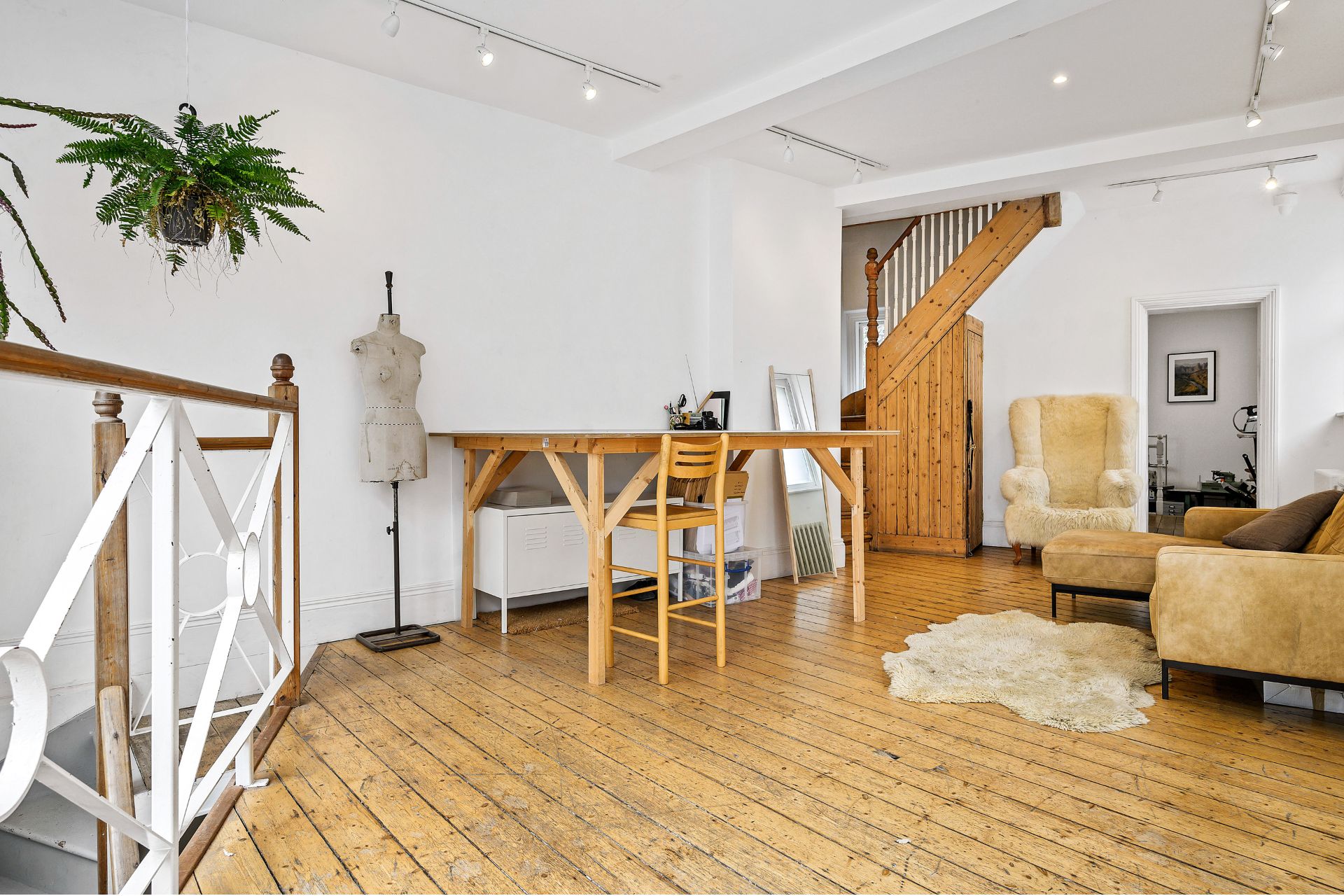 Living room with wooden floors, wooden table and sheepskin rug