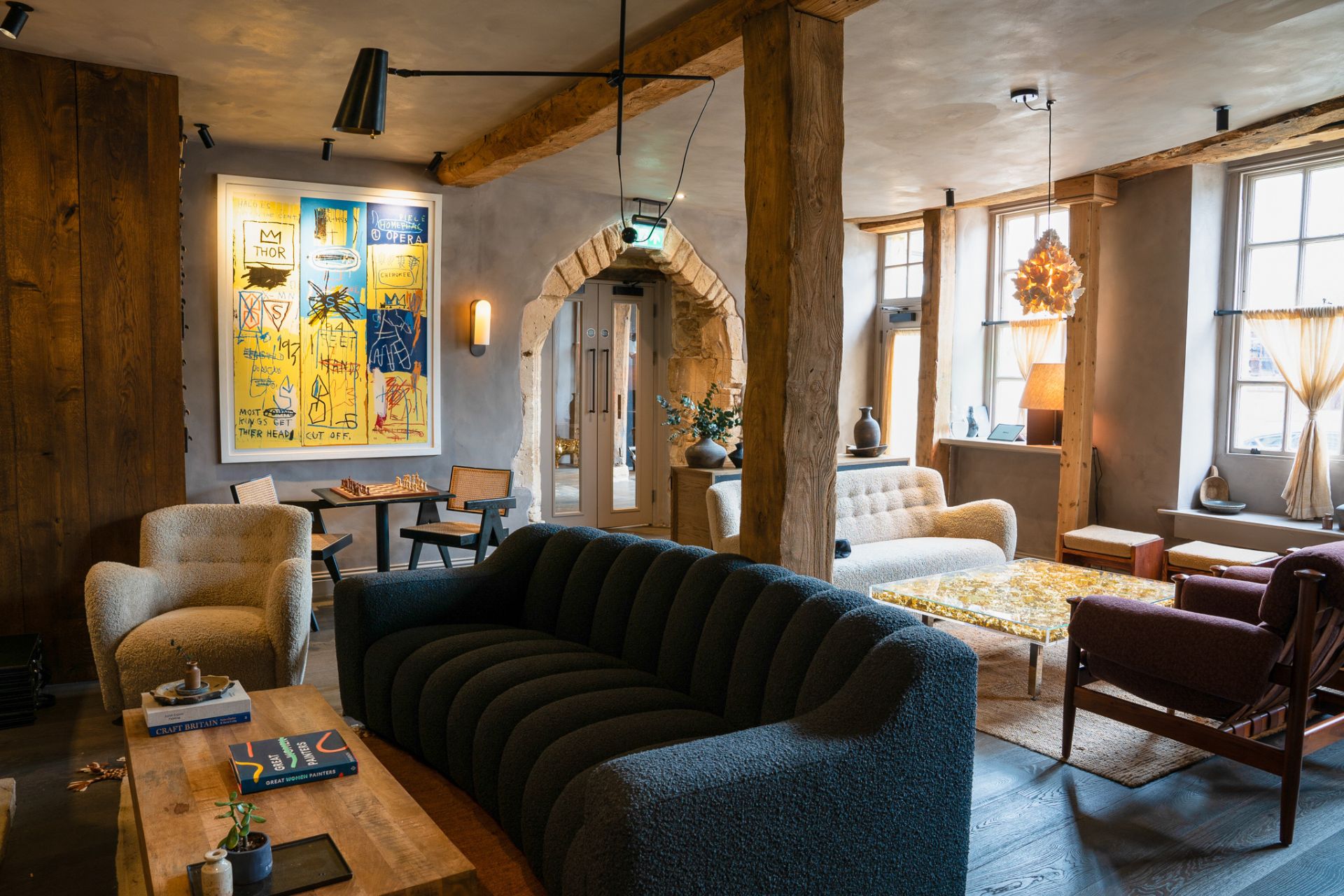 Lobby pace with navy blue sofas and exposed brick.