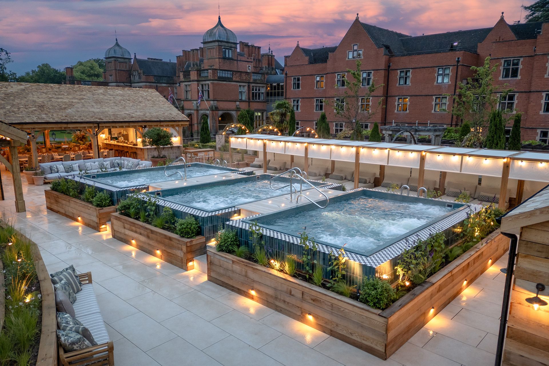 Hotel terrace with three outdoor pools decorated with fairy lights