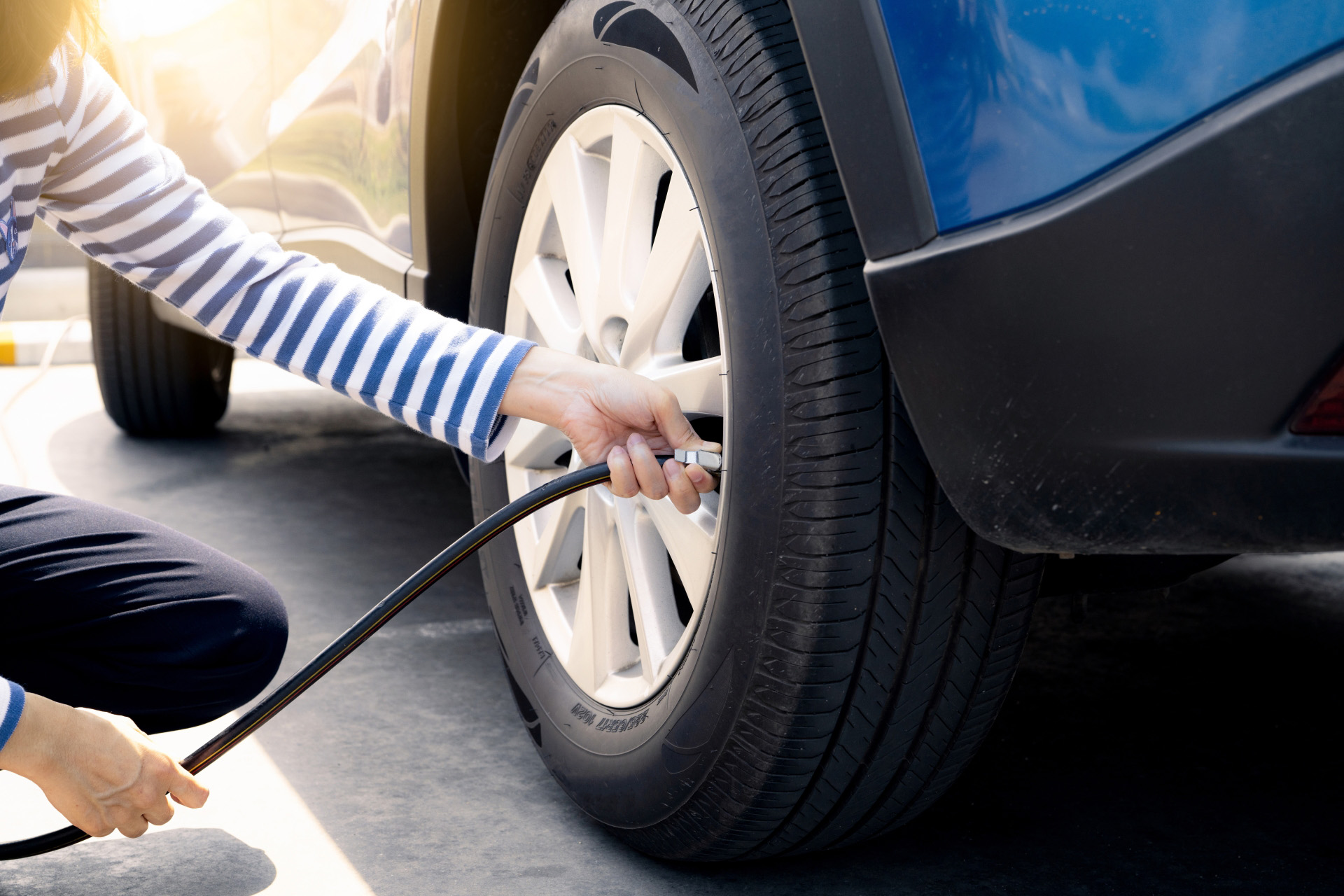 A woman filling up a tyre