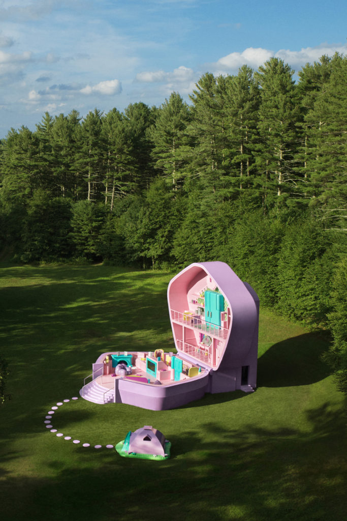 A giant Polly Pocket compact in a field with trees