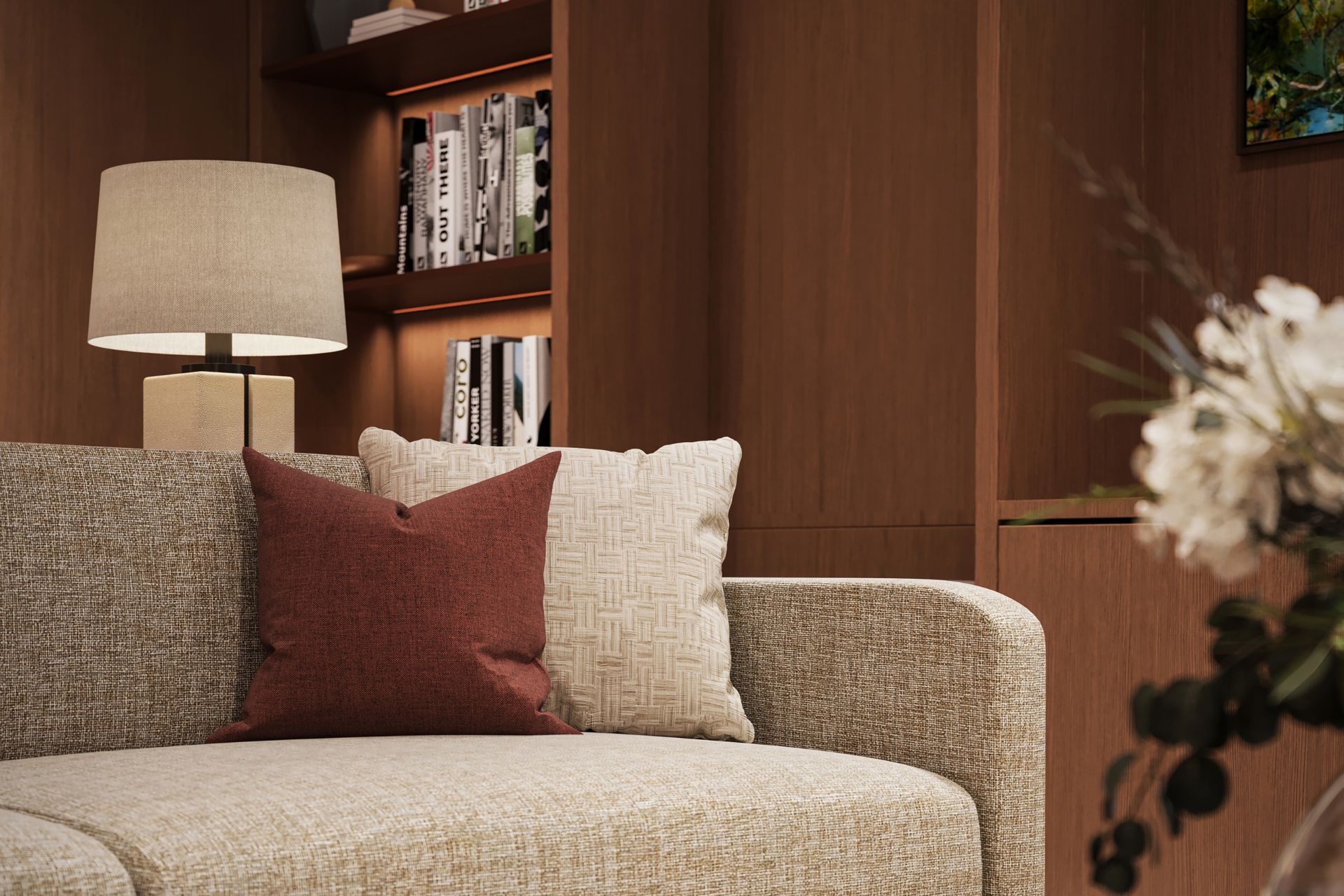 Library with beige sofa, dark red cushions and wooden built-in shelves