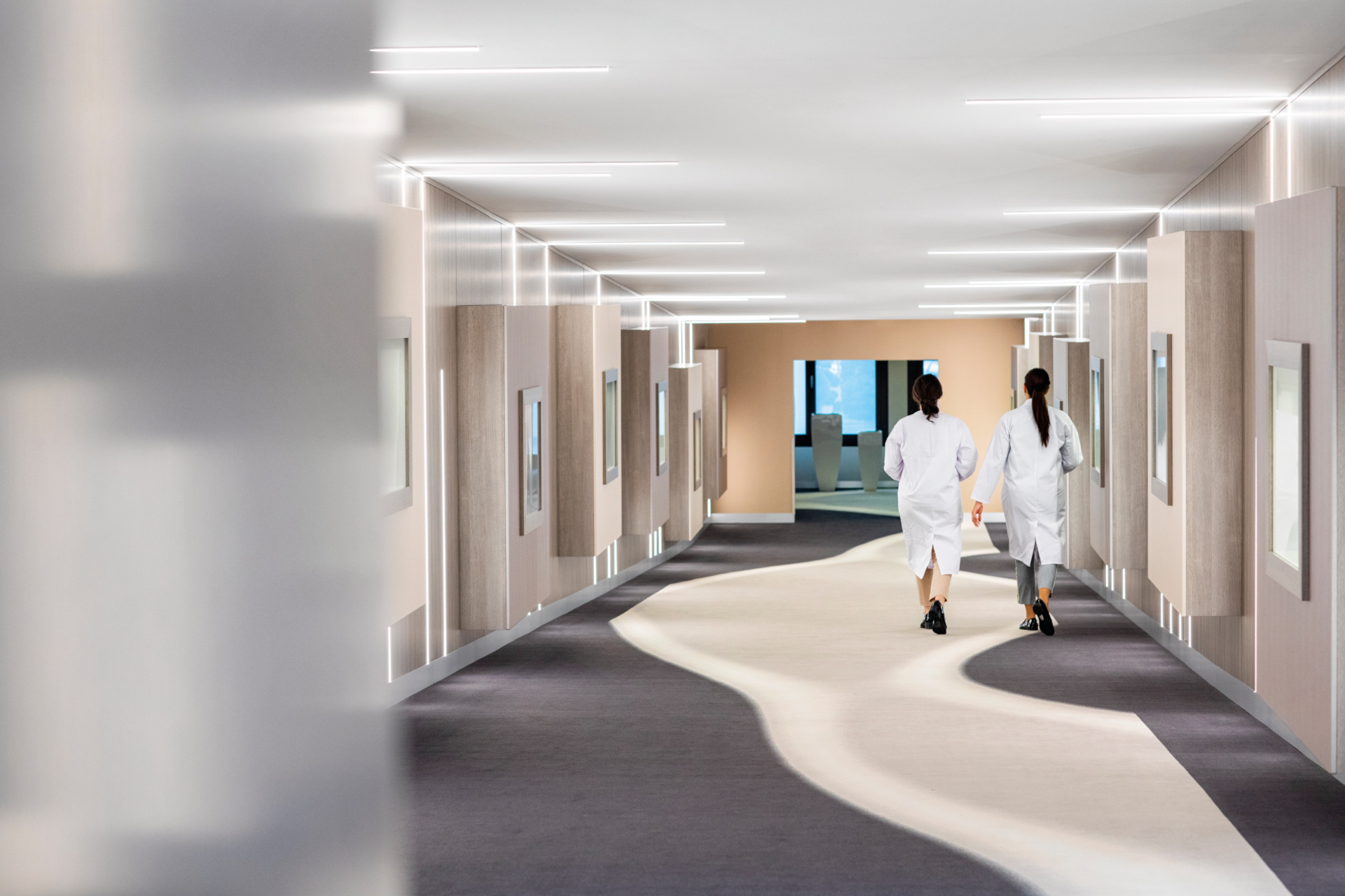 Hallway with people in white lab coats | Switzerland Health Clinics