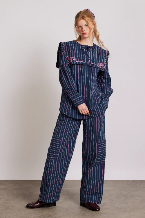 Woman in striped bedcore blouse and trousers
