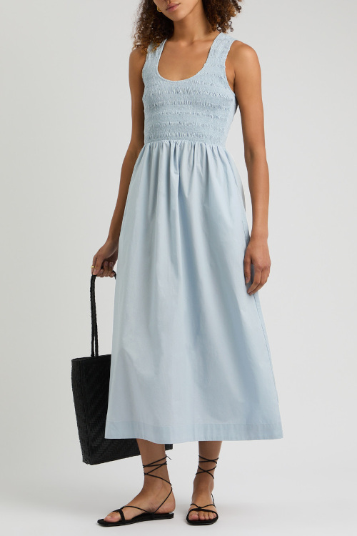 Woman in blue fit and flare dress