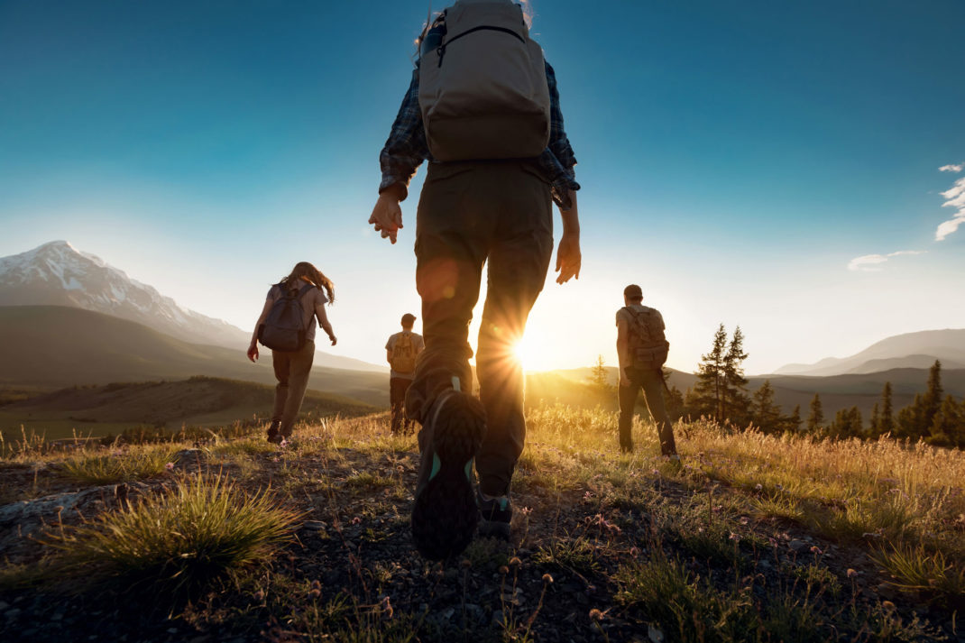 Group of people walking with backpacks