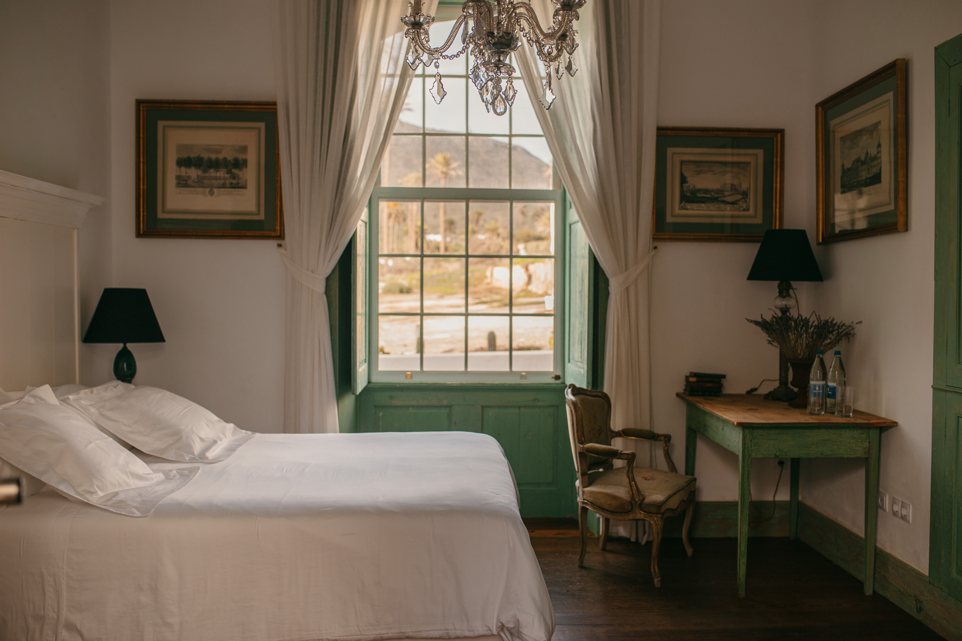 A bedroom with antique chandelier