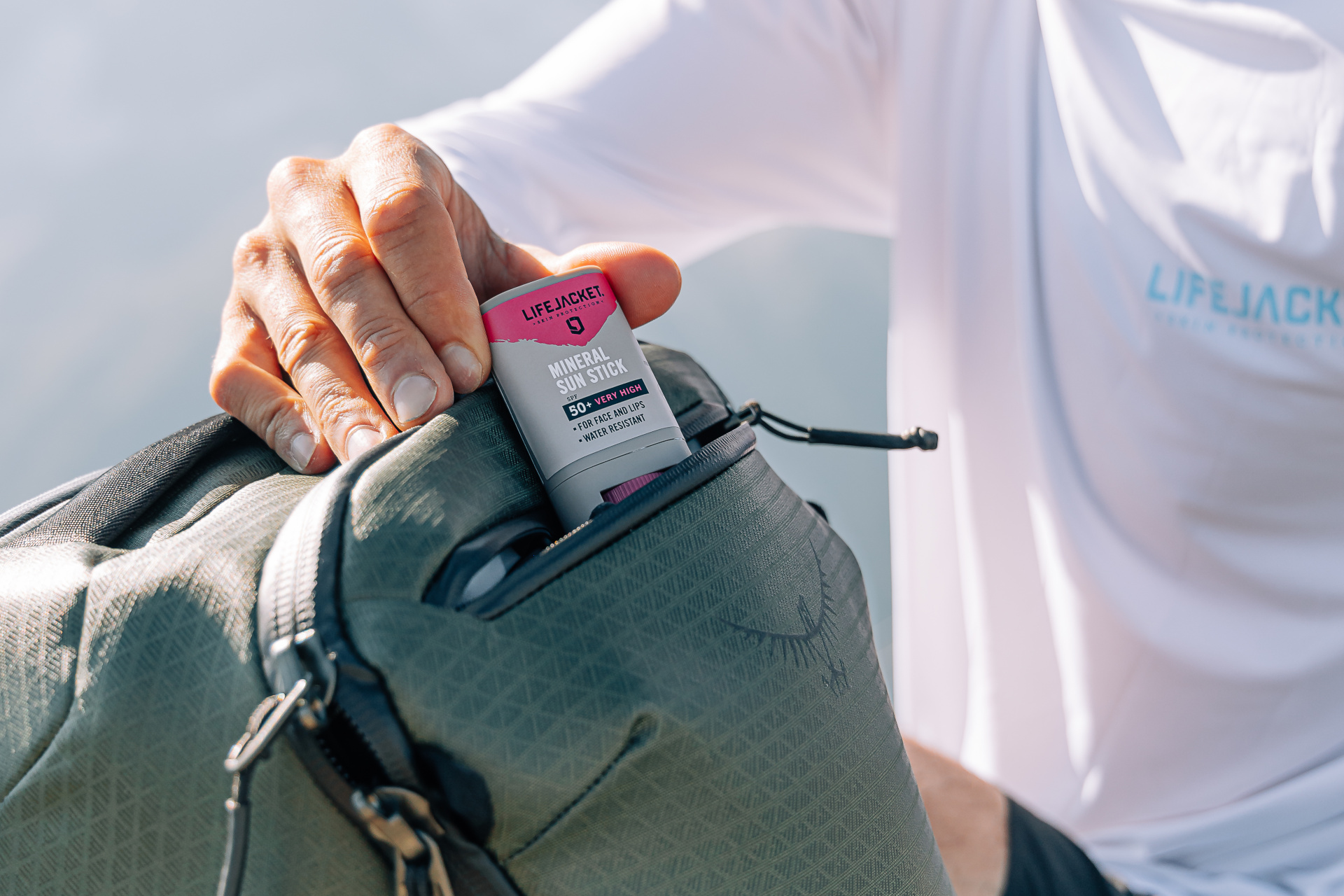 Close up of hands putting bottle in bag