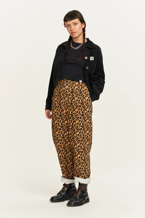 Woman in black top and leopard print jeans