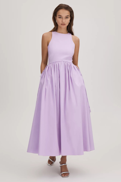 Woman in purple fit and flare dress