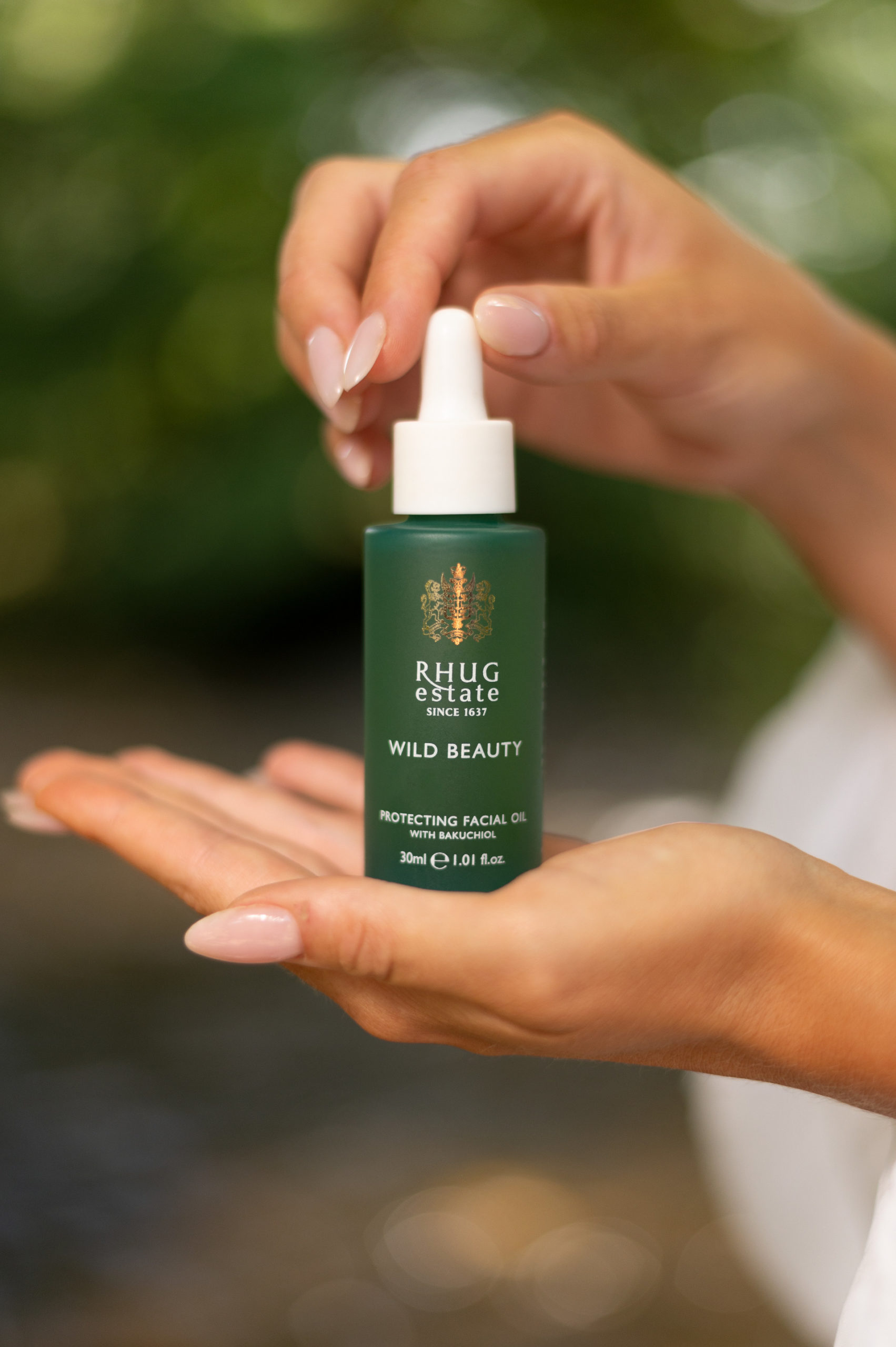 Close up of green bottle held in hands
