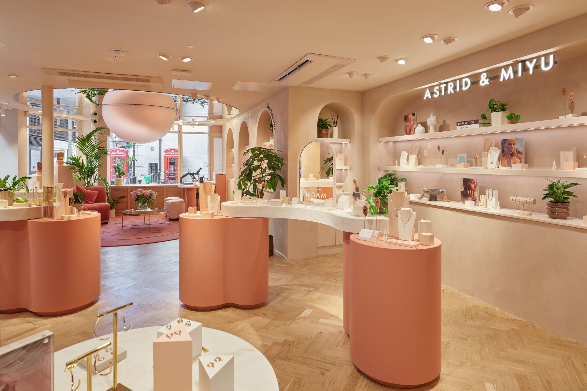 Pink Astrid & Miyu ste with curvedpink tables and white shelves