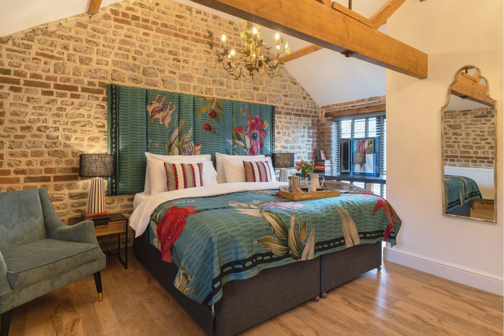 Bedroom with floral headboard brick wall
