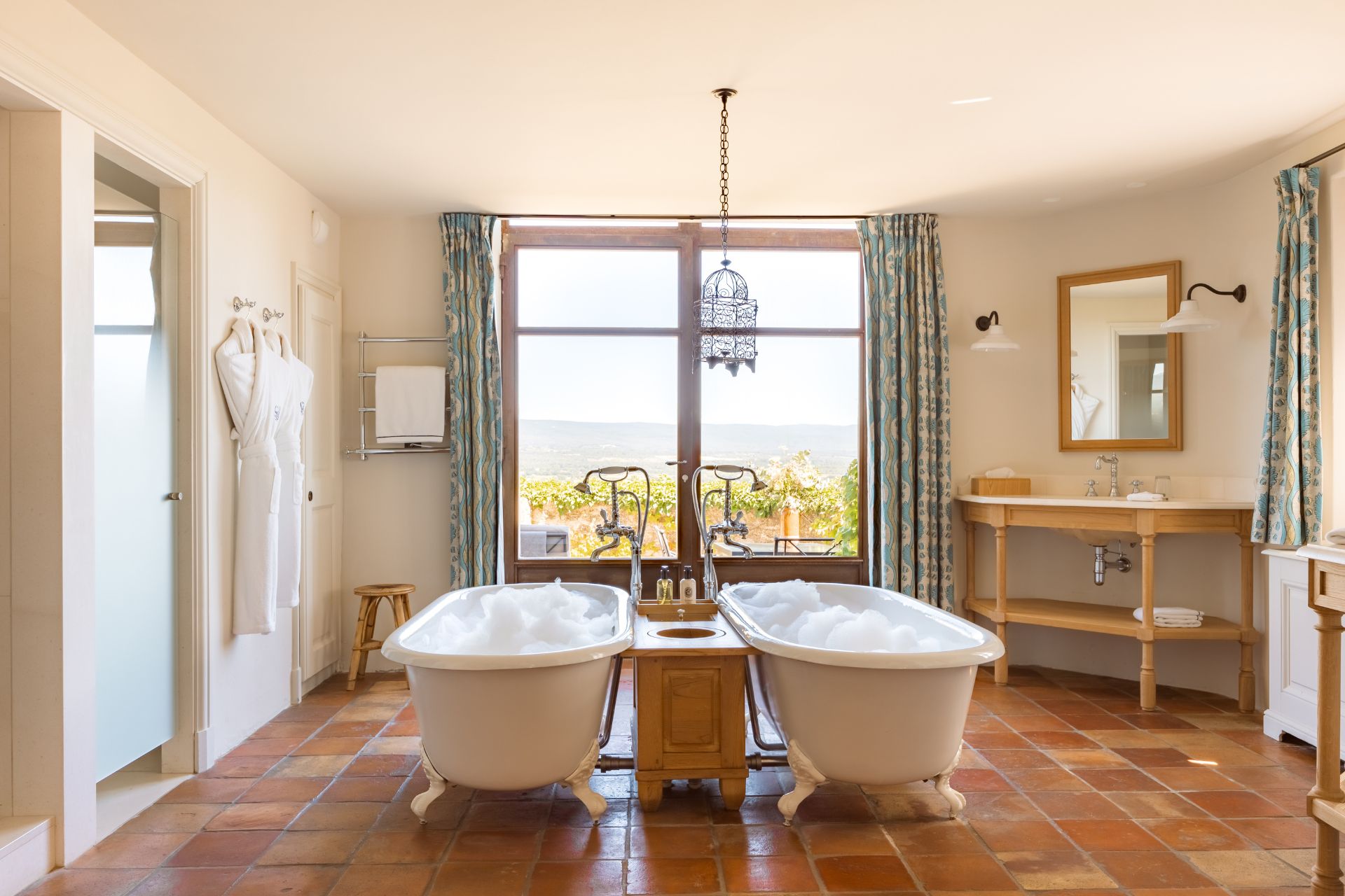 Hotel bathroom with two freestanding bathtubs