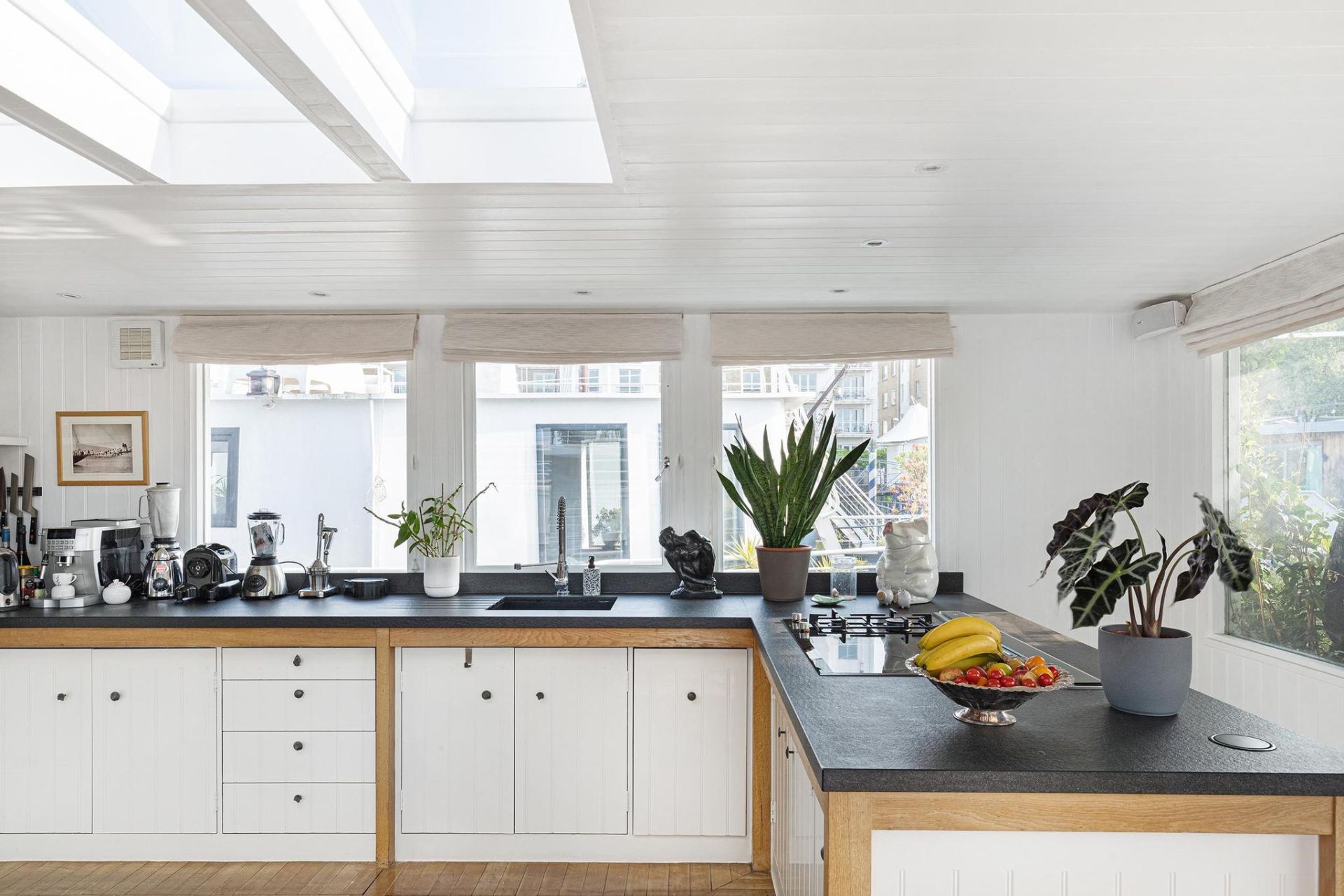 Houseboat kitchen with white cabinets and black countertops