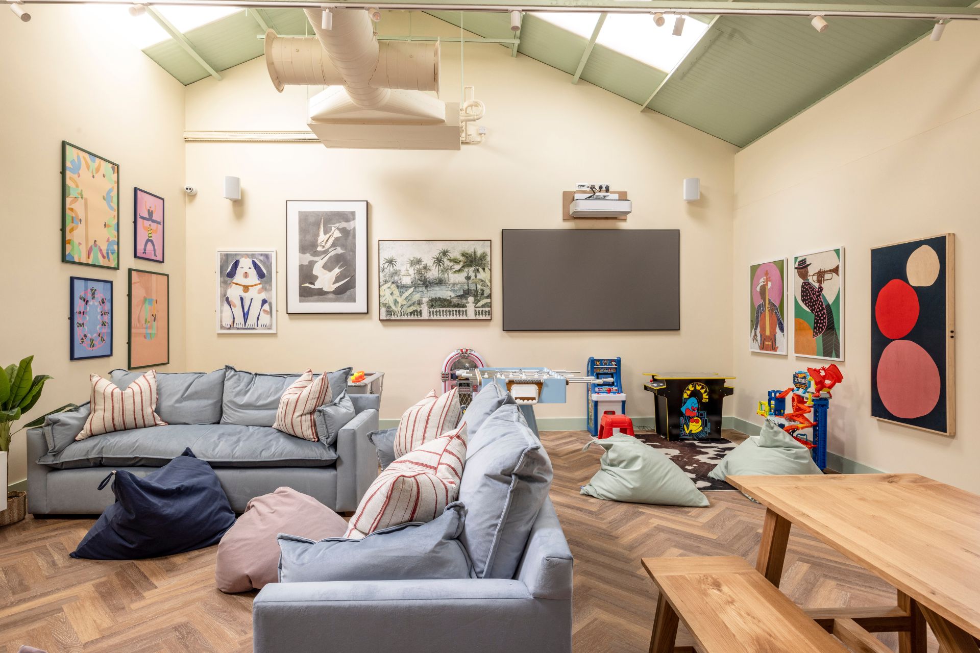 Living room with pale blue sofas, bean bags and a wooden table