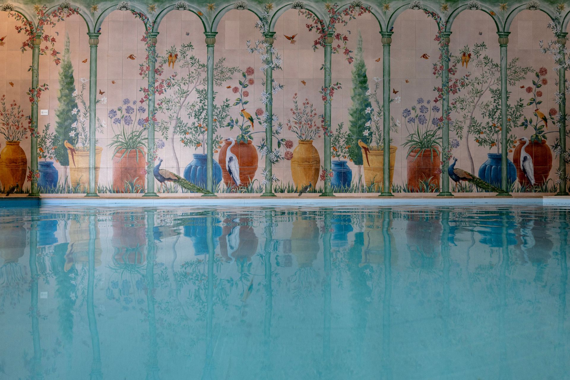 Indoor pool with floral wall motifs
