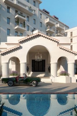 Art Deco-style residential building with a pool and a classic car outside
