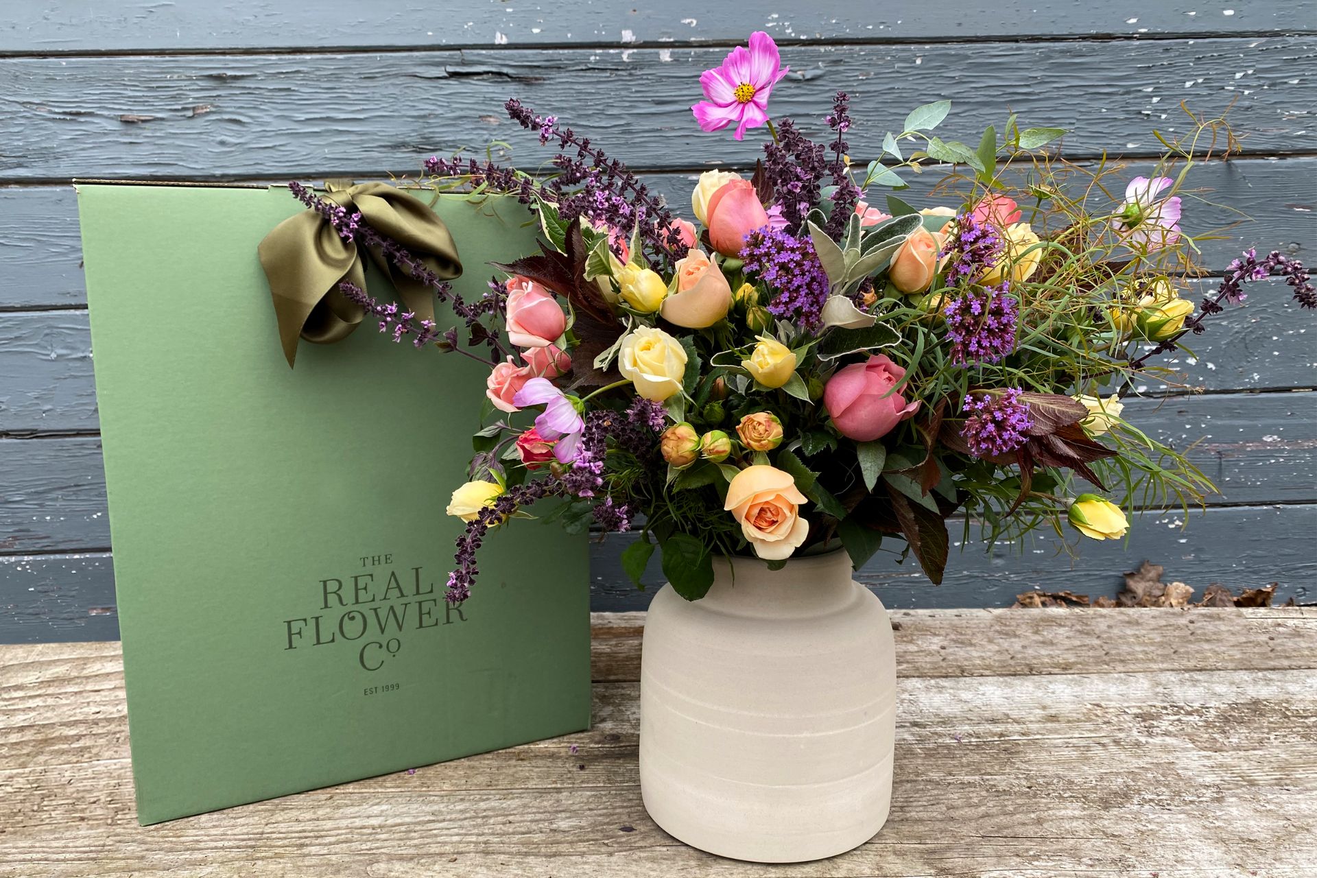 Bouquet of yellow and pink roses and sprigs of lavender.