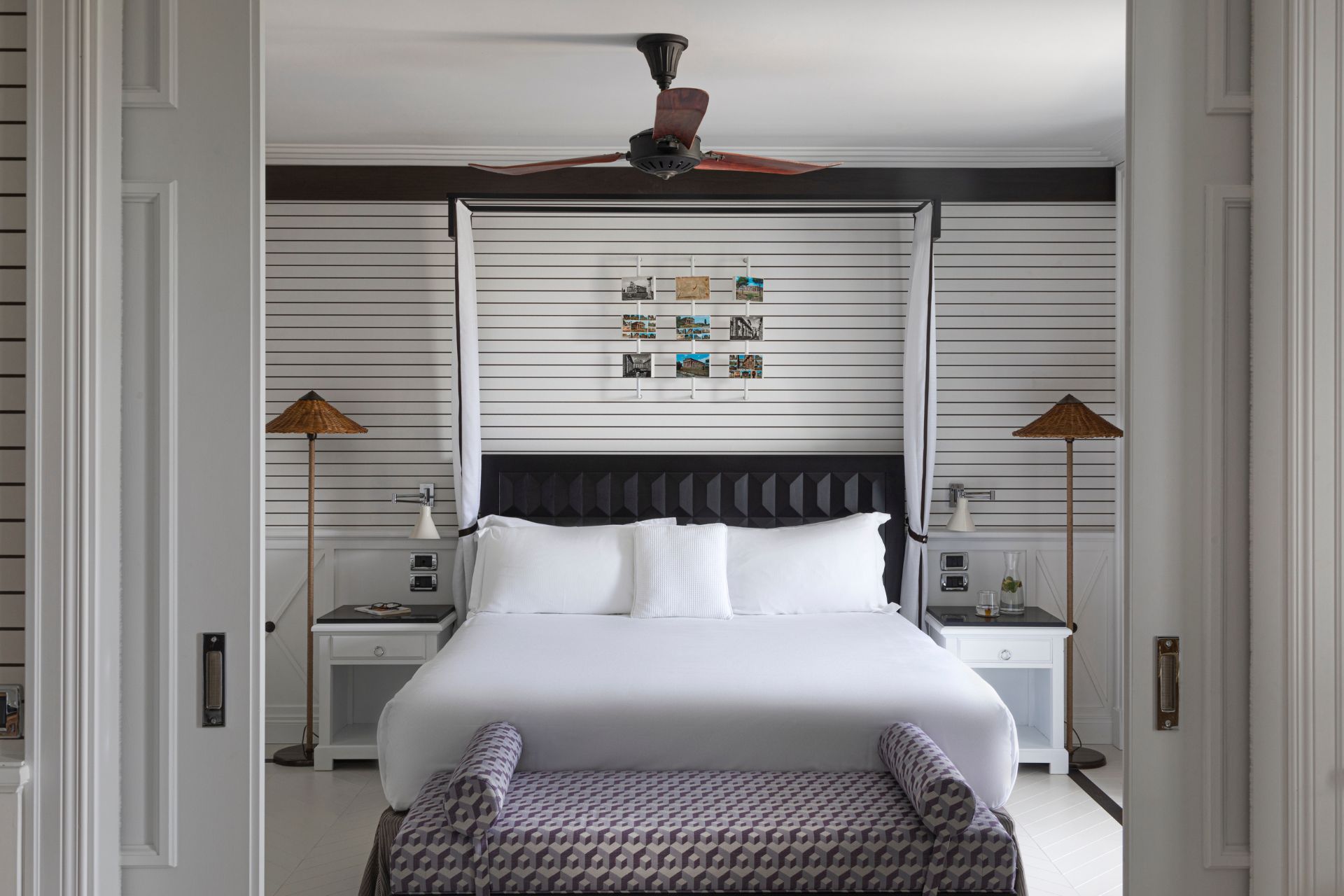 Hotel room with white, wood-panelled walls