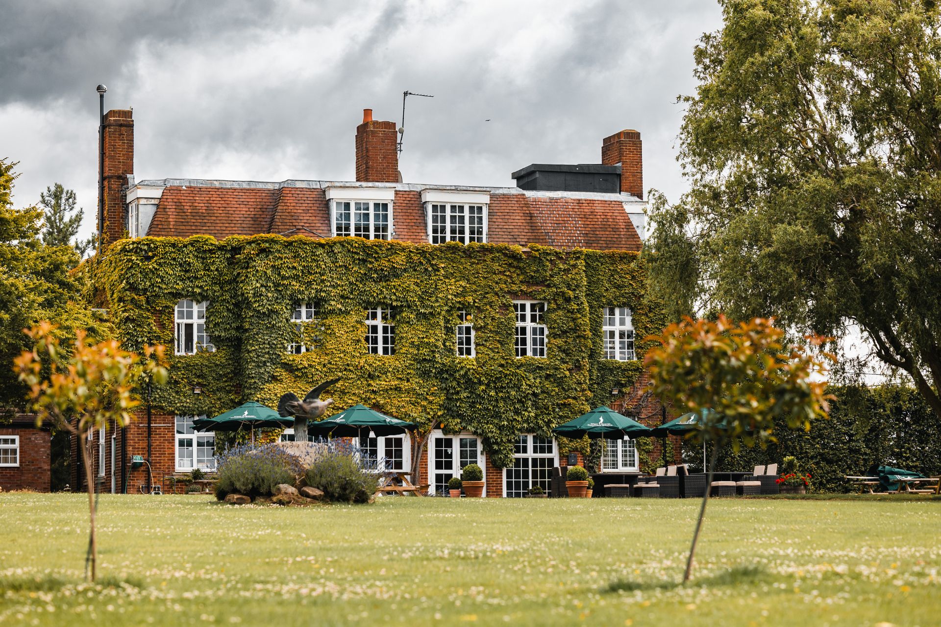 Exterior of West London Shooting School with ivy-clad facade