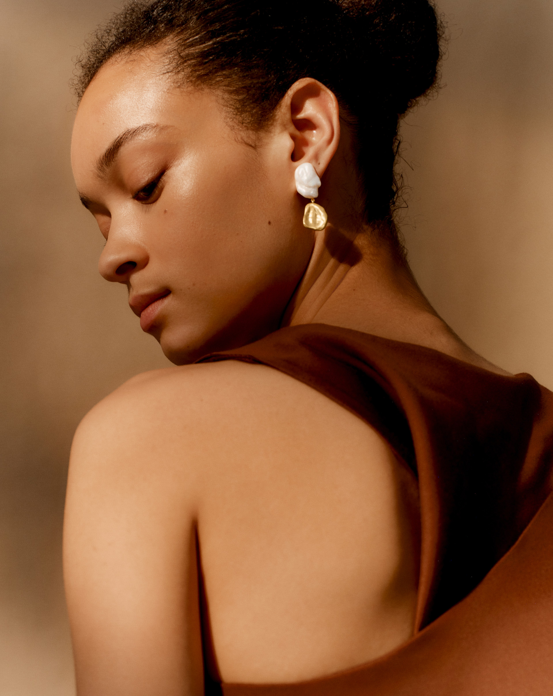 Woman wearing red top and Amy Powney x Monica Vinader earrings