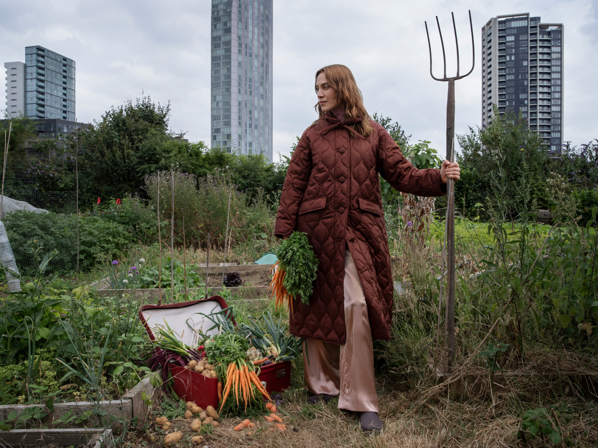 Alexa Chung wearing brown coat in allotment