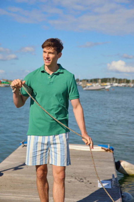 Man in green polo and shorts