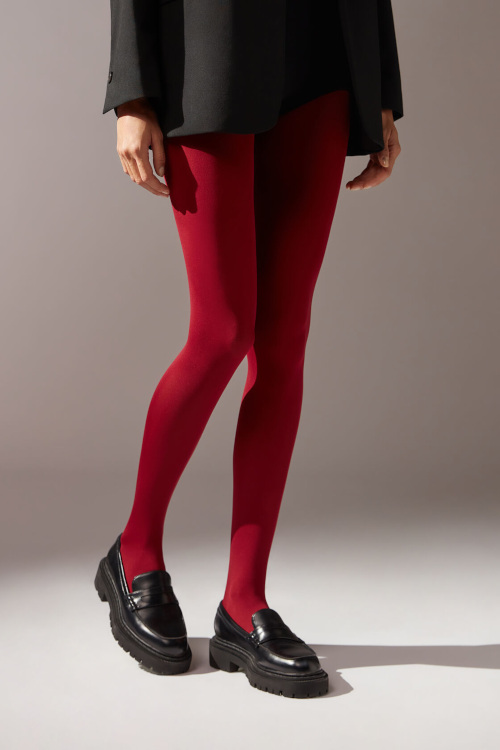 Legs in red tights and black loafers