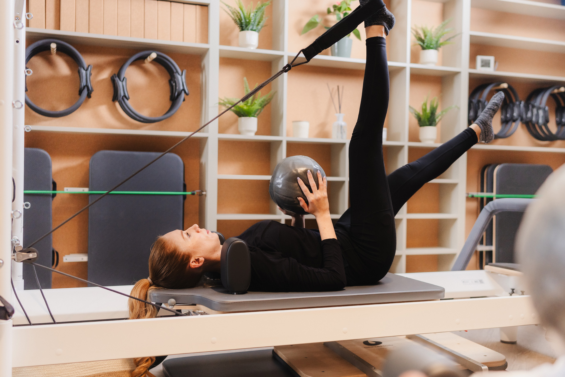 Woman doing reformer pilates