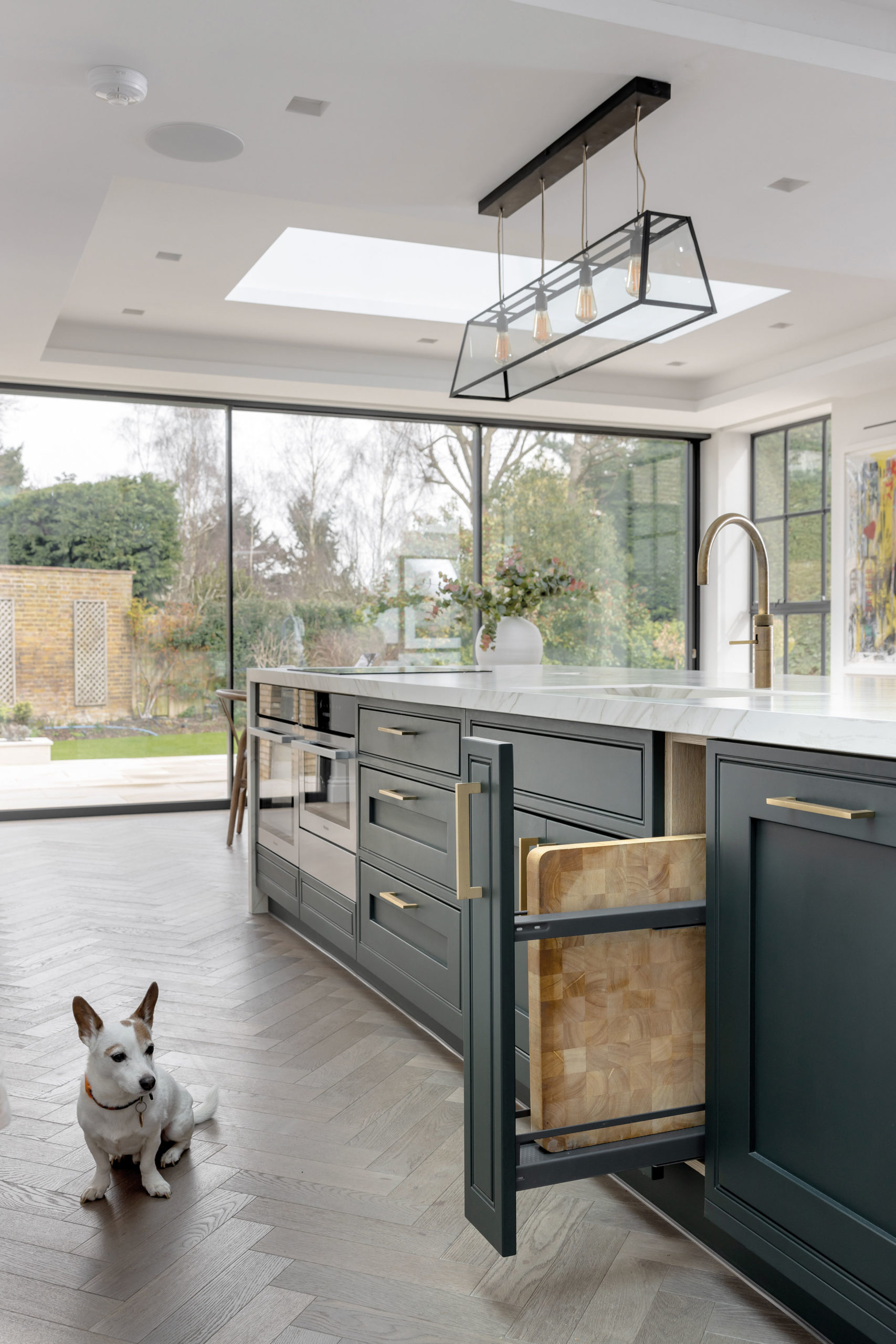 Will Greenwood's kitchen island with dog stood by it
