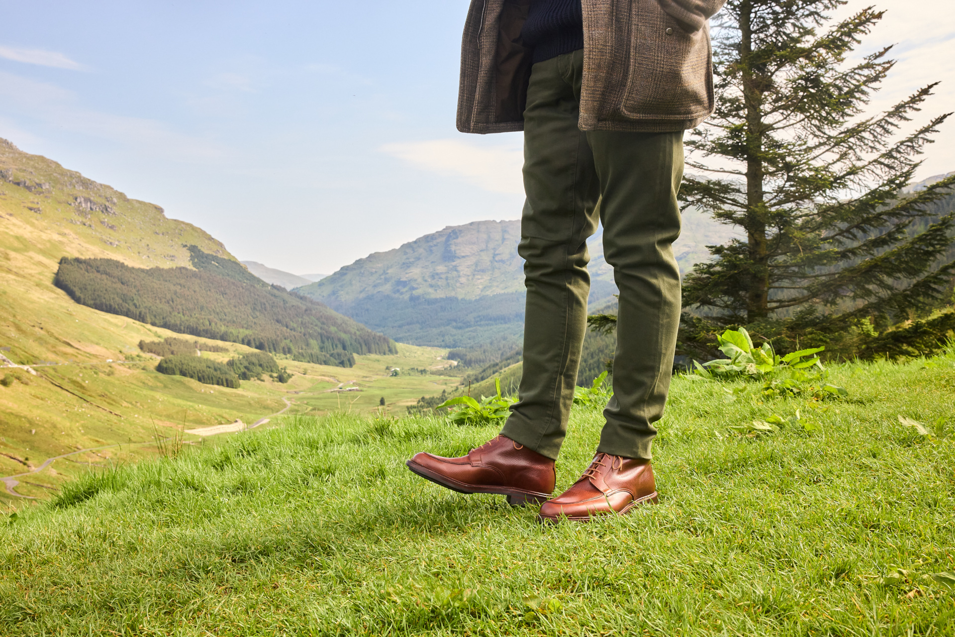Close up of someone's legs and feet in a rolling valley