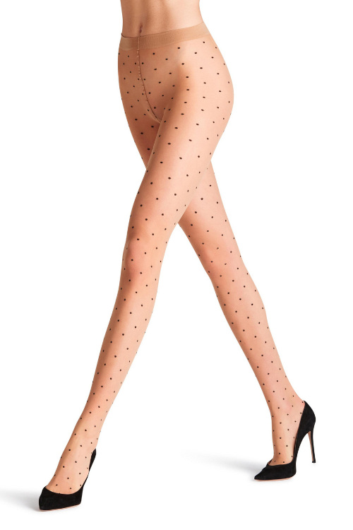 Legs wearing black heels ans nude tights with black dots